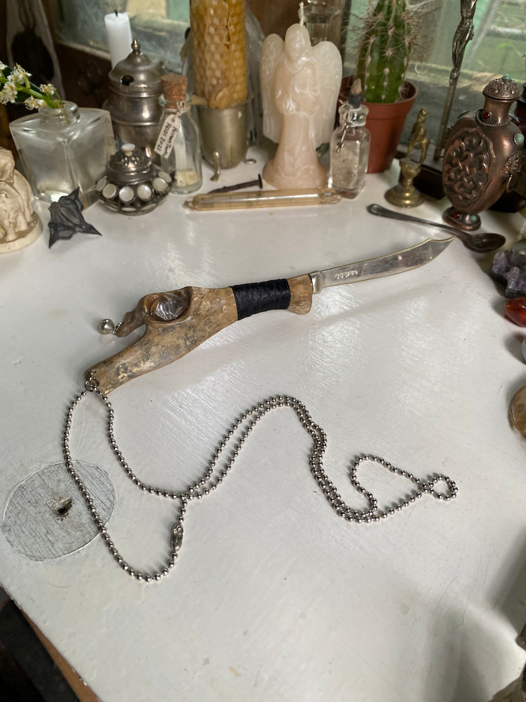 Fossilised Bone Knife with Chain, Bell and Clear Bead  image 0