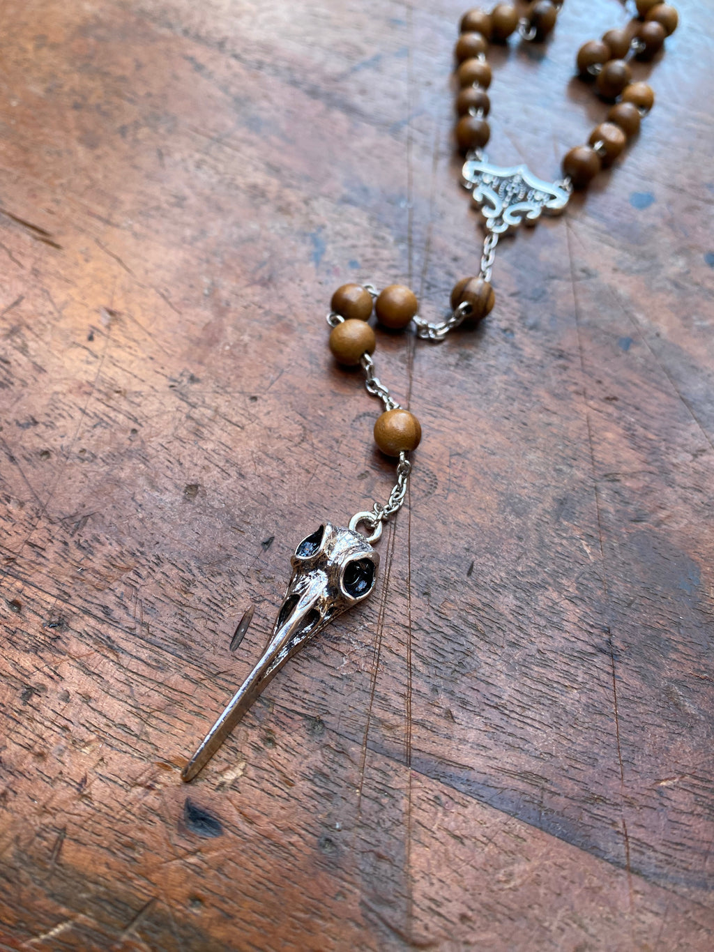 Wooden Bead Rosary with Bird Skull
