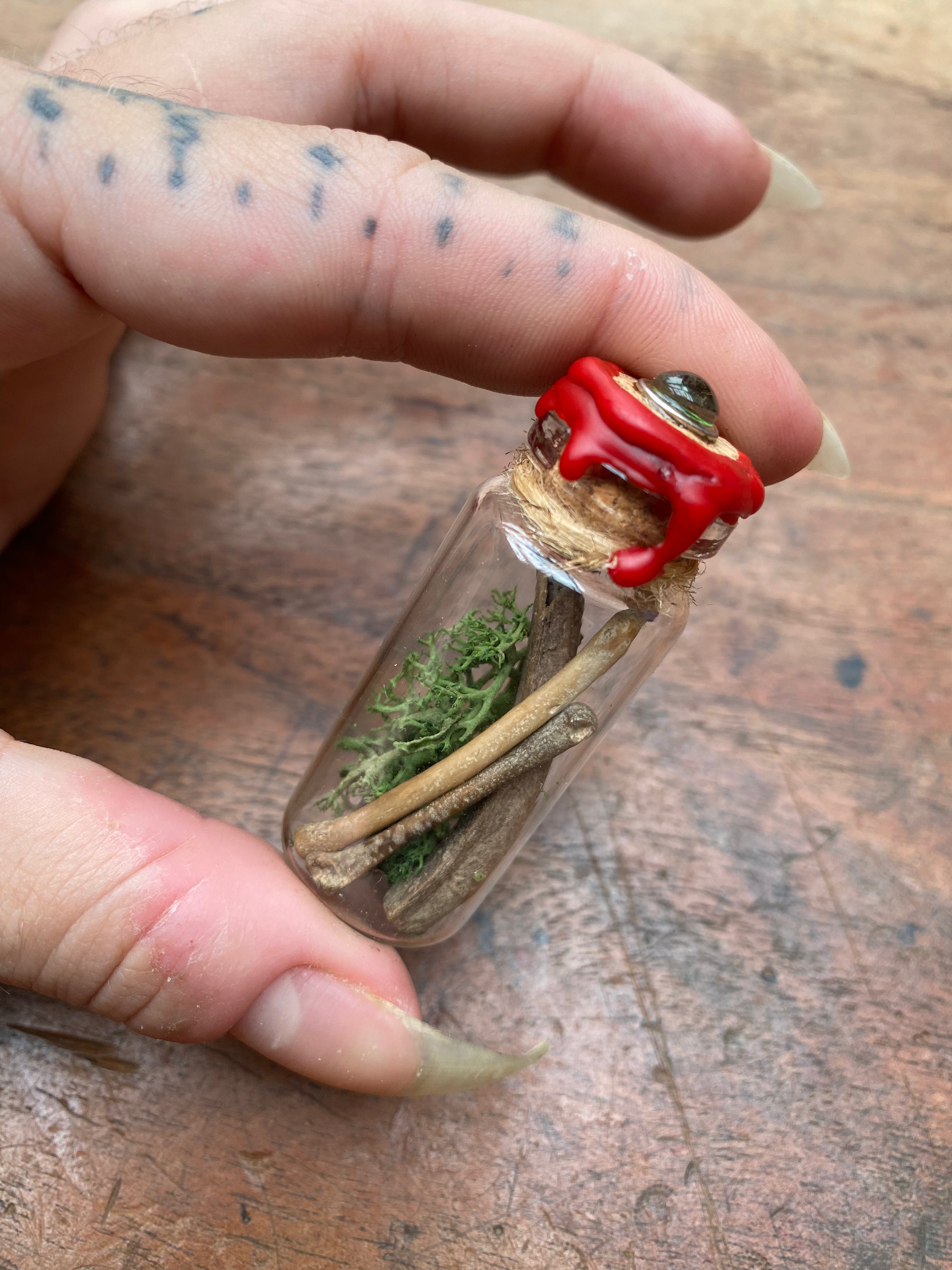 Fossilised Mudlarked Bones in Glass Vial with Eye Spell Jar