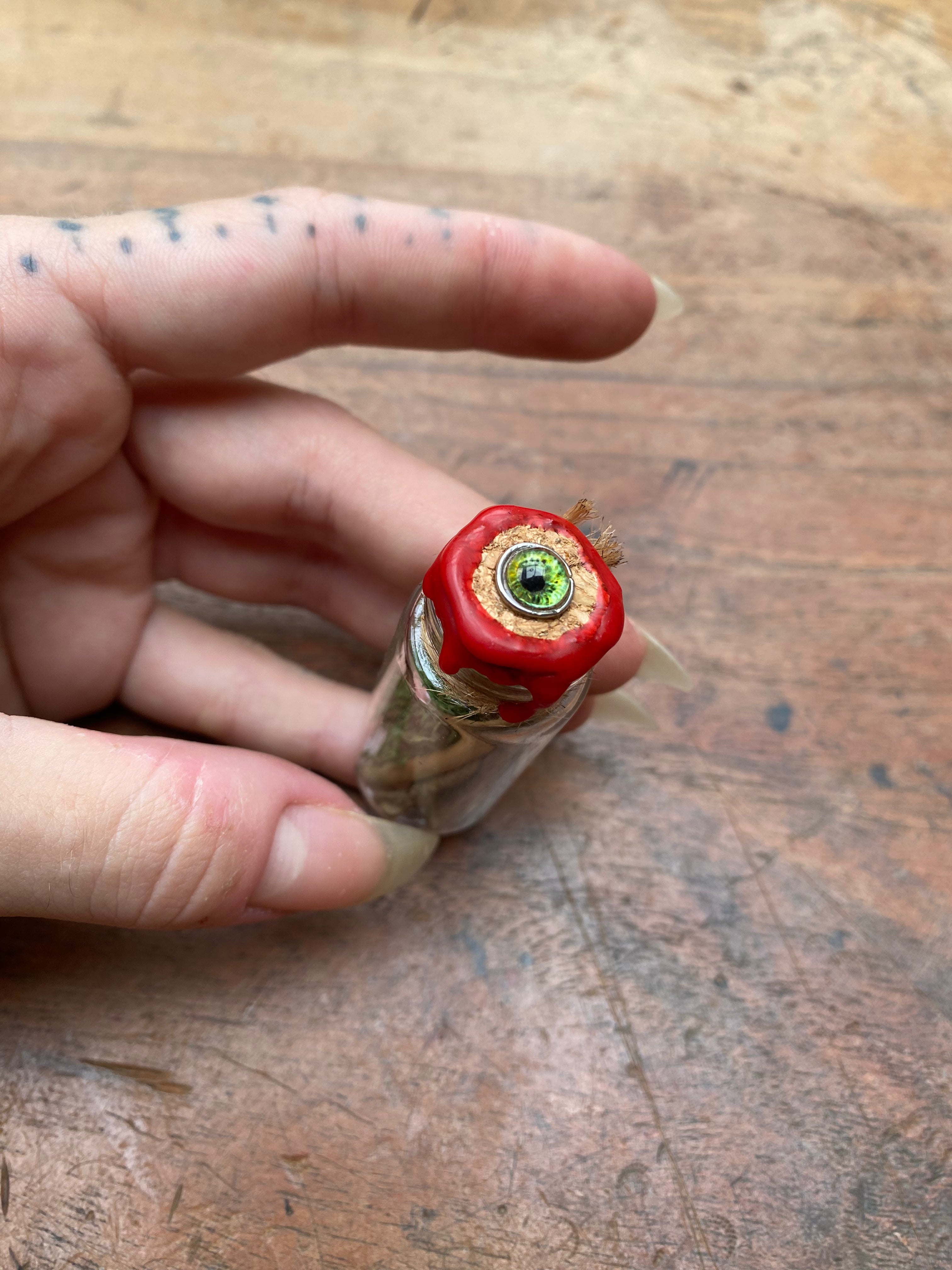 Fossilised Mudlarked Bones in Glass Vial with Eye Spell Jar